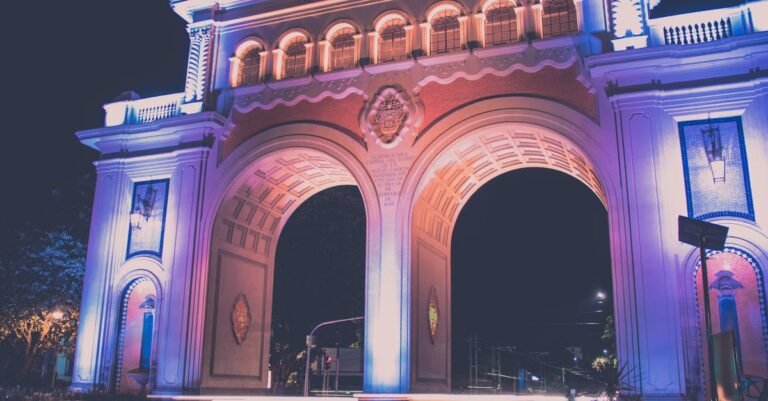 Beautiful nighttime view of an illuminated arch in Guadalajara, showcasing vibrant lighting and urban scenery.